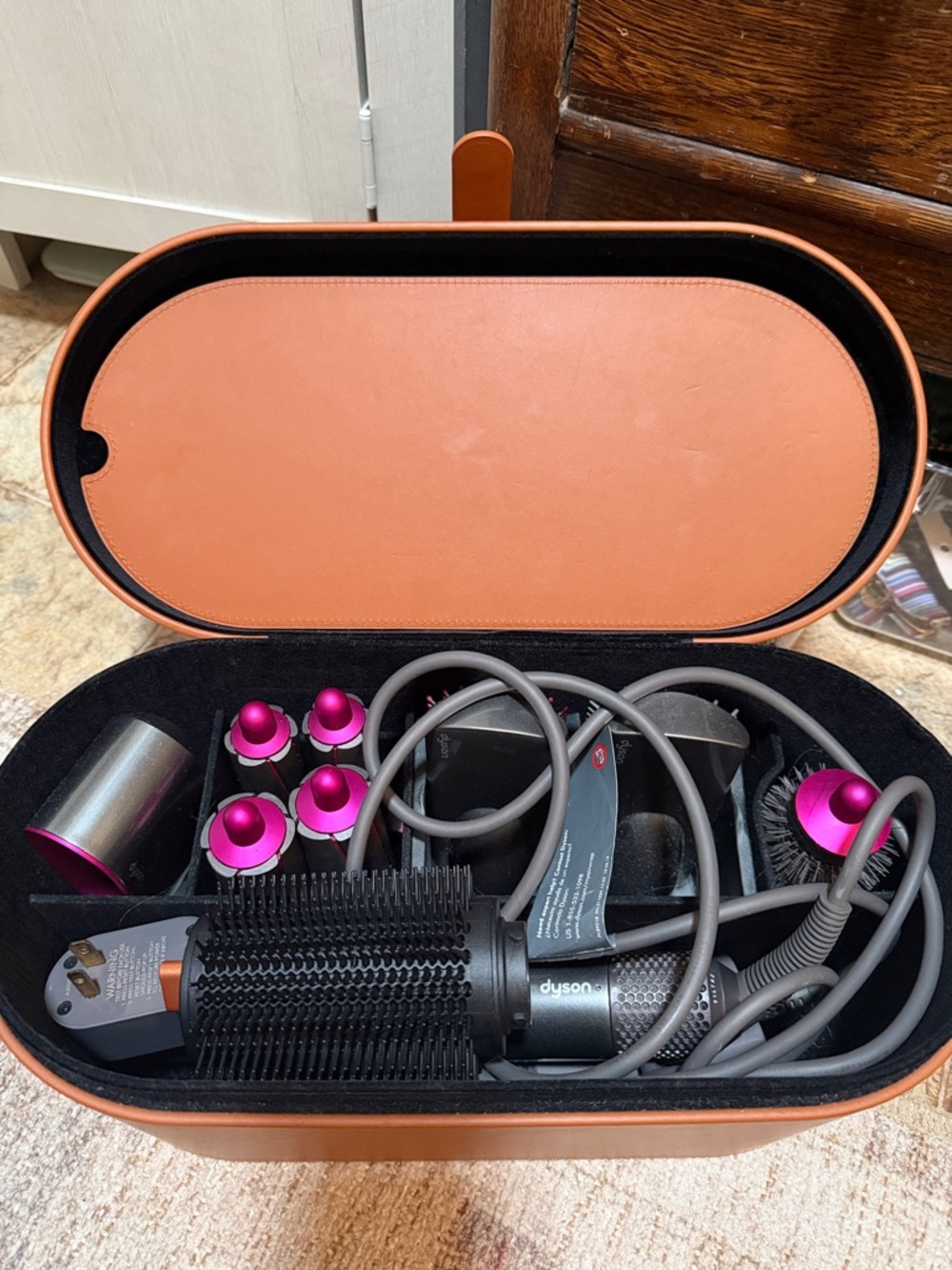 Dyson styling set with pink accents and tan case